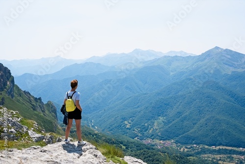 Lonely traveler woman looking at the mountains in Fuente De  Spain