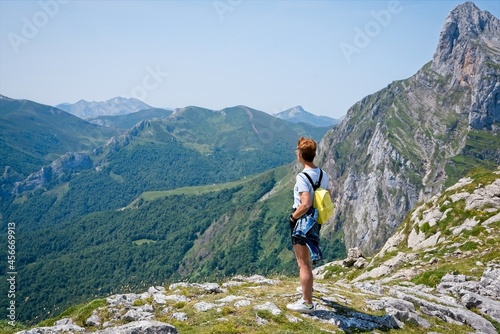 Rear view of a lonely woman looking at the mountains 
