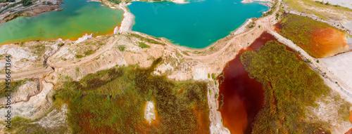 Colored lakes among rock dumps of abandoned quarry, aerial view photo