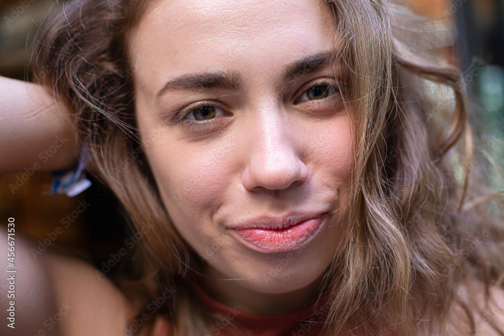 European young girl with dark and curly hair close-up portrait