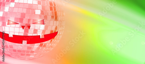 mirror ball with halluin face on colored background with highlights photo