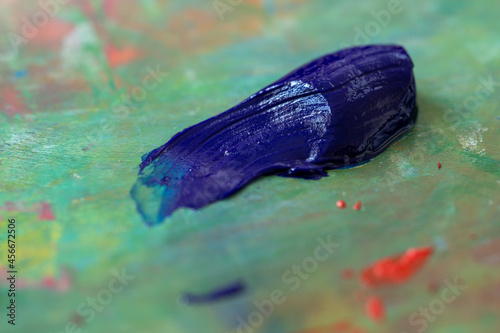 Blue oil paint on a palette. Extruded blue paint on a professional multicolor palette. Stroke with oil paint.
