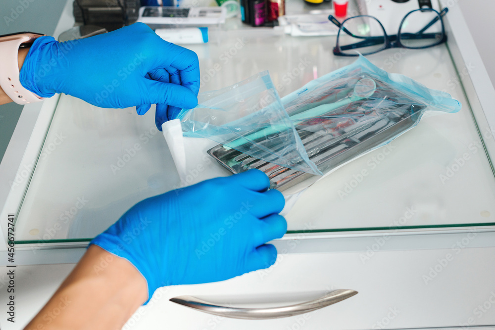 A dentist starts to examine a patient. Teeth care with dentist instruments. Dentist professional tools , close up. A dentist starts to examine a patient. Teeth care with dentist instruments. Dentist professional tools , close up.