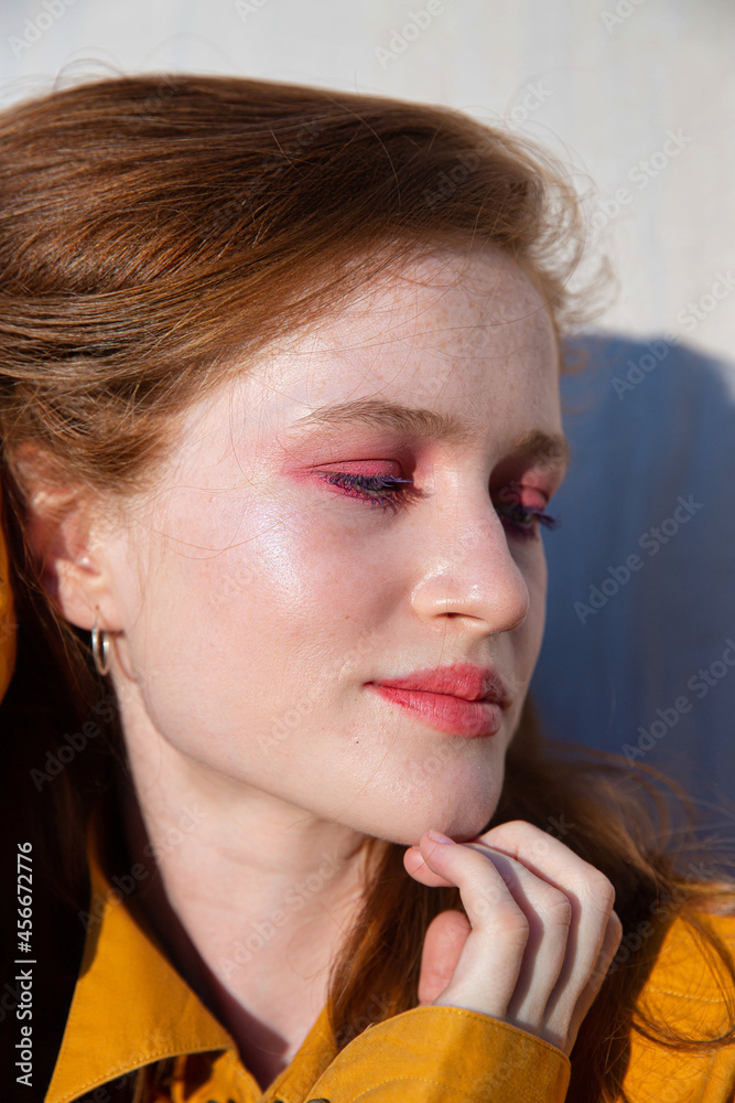 Portrait young girl with bright makeup near the wall Portrait young girl with bright makeup near the wall