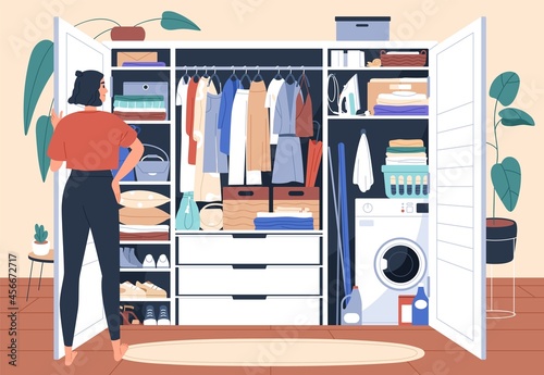 Wardrobe after decluttering and putting in order. Woman in front of tidy closet with organized arranged storage system for clothes, folded on shelves and hanging on racks. Flat vector illustration