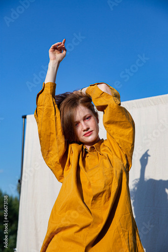European girl with bright makeup in yellow clothes