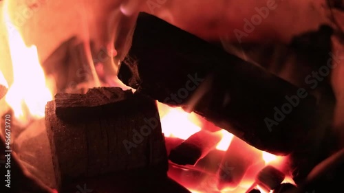 Video Close-up view of a burning fire in a charcoal furnace with black coals inside the furnace.