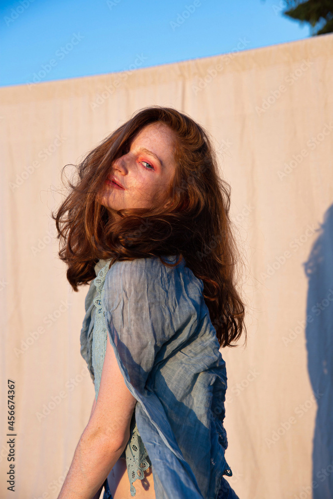 Fototapeta premium White european young woman with bright makeup with red hair
