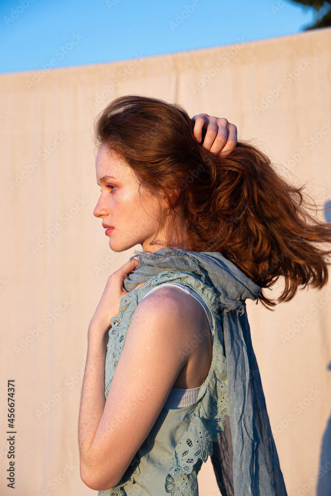 Fototapeta premium White european young woman with bright makeup with red hair