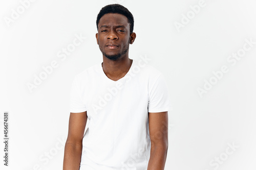 african man in appearance white t-shirt on a light background