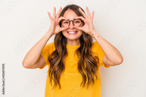 Young caucasian woman isolated on white background excited keeping ok gesture on eye. © Asier