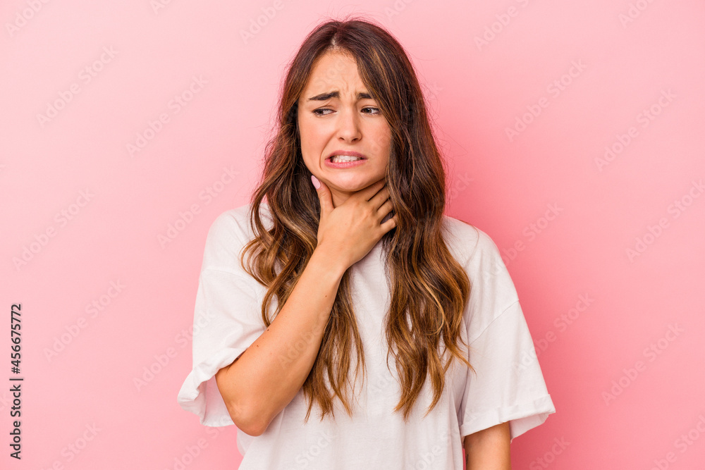 Young caucasian woman isolated on pink background touching back of head, thinking and making a choice. Young caucasian woman isolated on pink background touching back of head, thinking and making a choice.