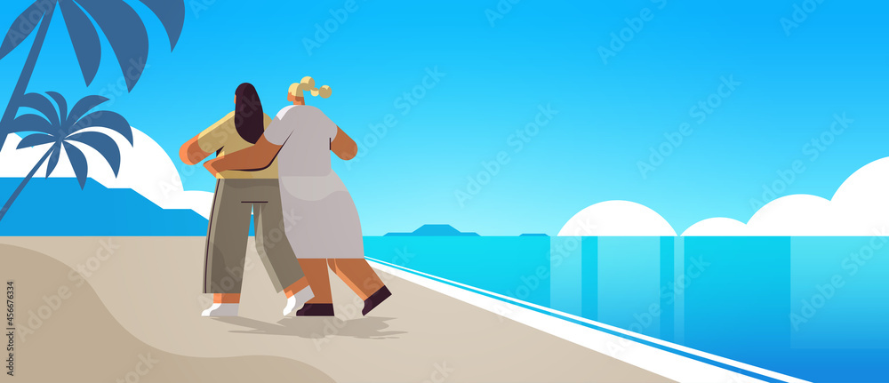 two girls hugging on beach gay lesbian love parade pride festival transgender love concept seascape background two girls hugging on beach gay lesbian love parade pride festival transgender love concept seascape background