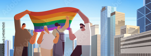 people with lgbt rainbow flag walking on city street gay lesbian love parade pride festival transgender love