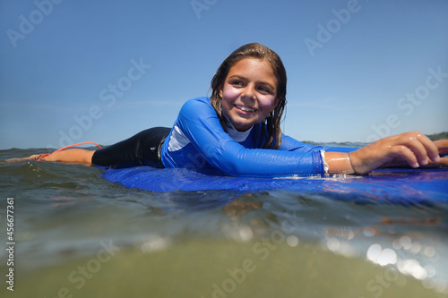 Photography young girl surfing in summer at the beach