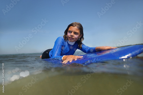 Photography young girl surfing in summer at the beach