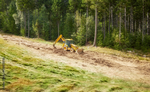Wallpaper Mural Backhoe levels hill surface for a ski slope. Torontodigital.ca