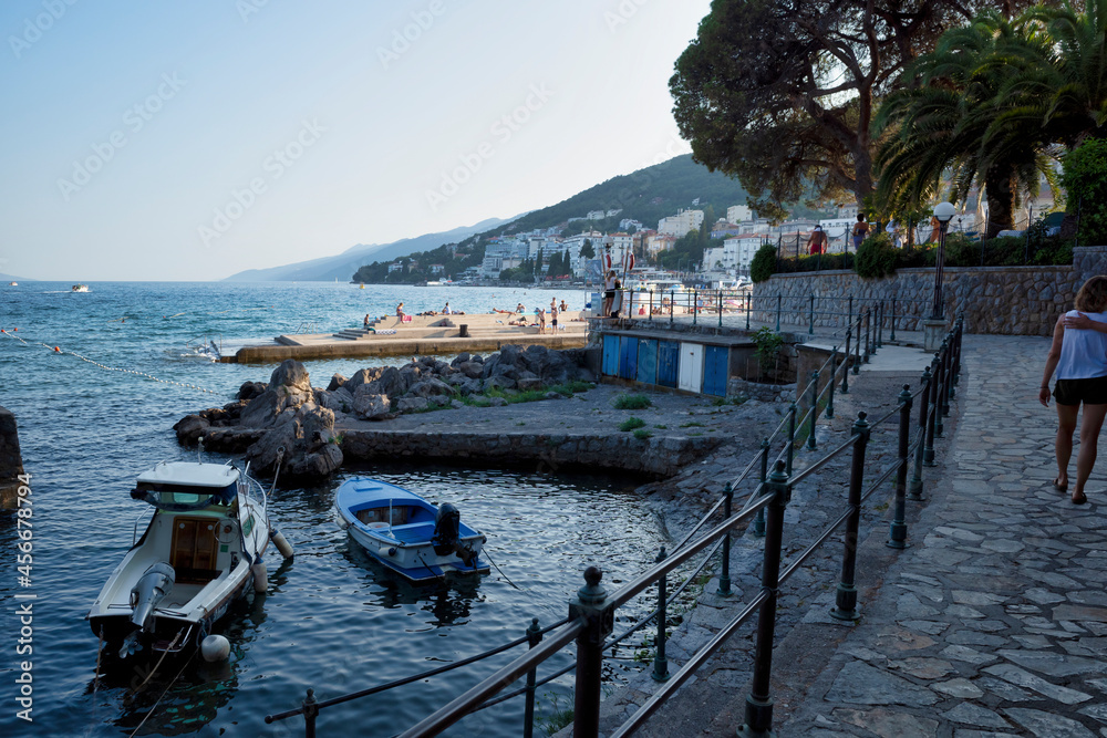 Rijeka, Croatia - August 11, 2021: Resort on the Adriatic Sea. City beaches, vegetation and buildings in Croatia. Seascape with a stone shore.