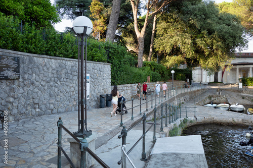 Obraz na płótnie Rijeka, Croatia - August 11, 2021: Resort on the Adriatic Sea. City beaches, vegetation and buildings in Croatia. Seascape with a stone shore. w salonie