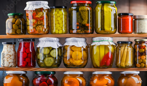 Jars with variety of marinated vegetables and fruits photo