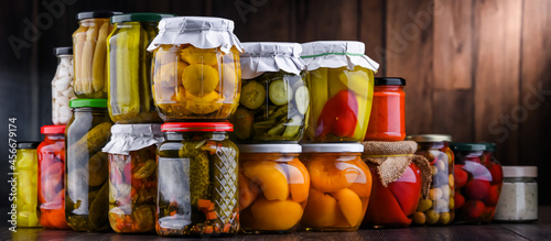 Bild auf Leinwand Jars with variety of marinated vegetables and fruits