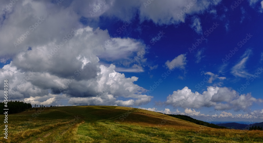 hill with different green from the grass and amazing clouds on the blue sky panorama hill with different green from the grass and amazing clouds on the blue sky panorama