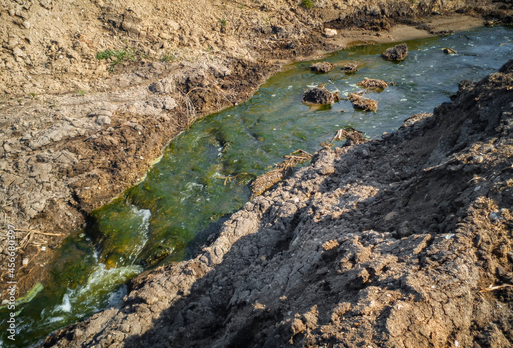 Rise of groundwater at a construction site. Powerful stream. Green water. IRTYSH River. Power of nature. Ust-Kamenogorsk (kazakhstan)