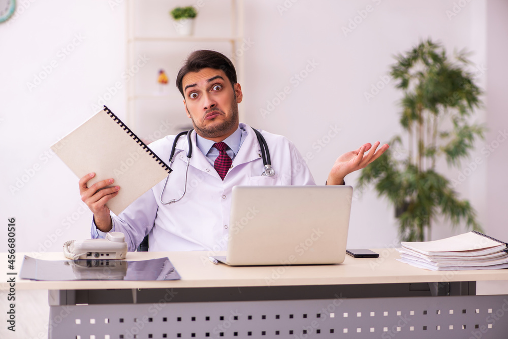 Young male doctor working in the clinic Young male doctor working in the clinic