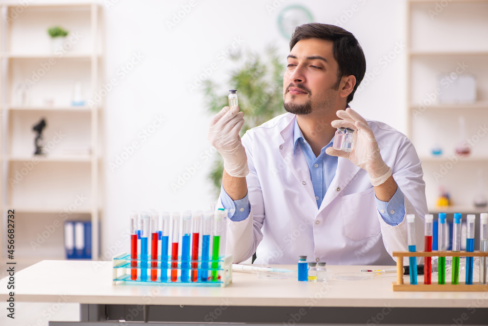 Young male chemist working at the lab Young male chemist working at the lab