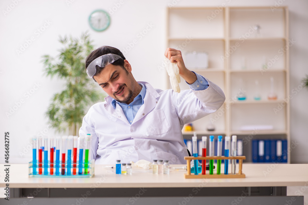 Young male chemist working at the lab Young male chemist working at the lab