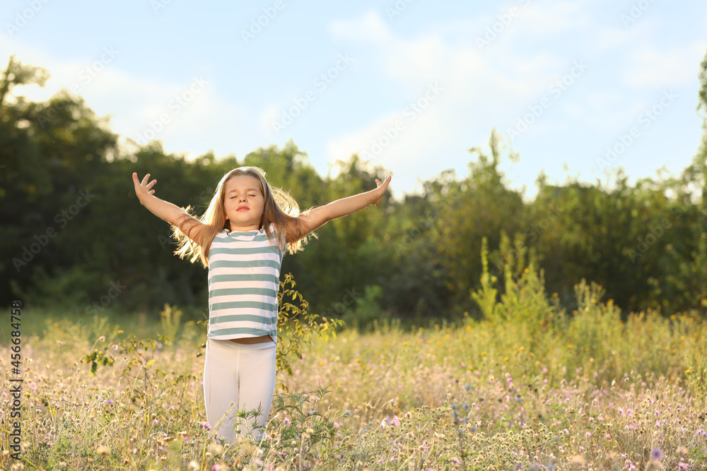 Cute little girl outdoors on sunny day. Child spending time in nature Cute little girl outdoors on sunny day. Child spending time in nature