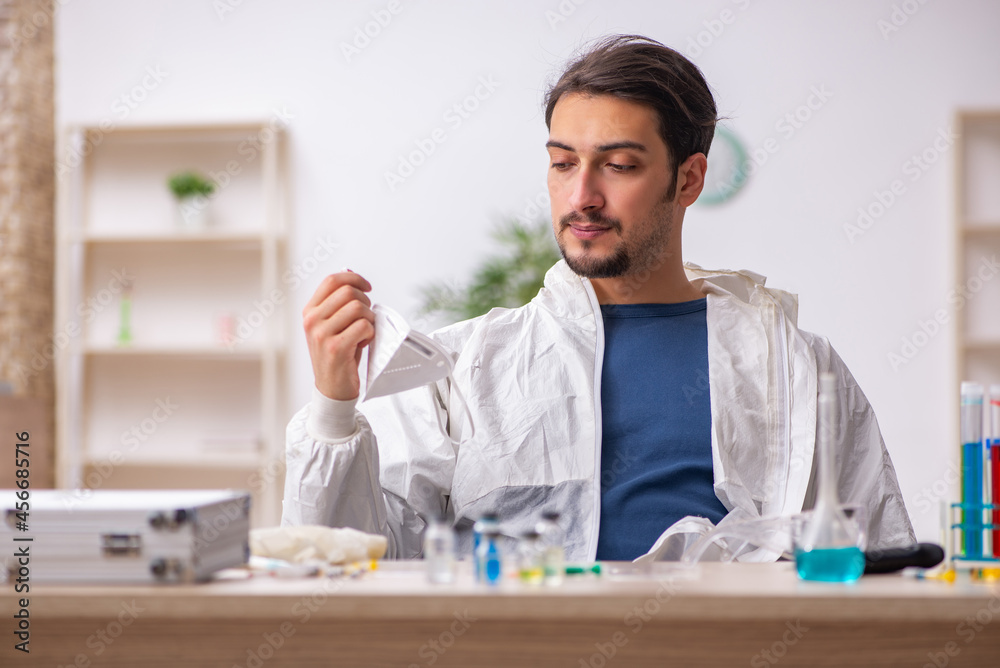 Young male chemist working at the lab during pandemic Young male chemist working at the lab during pandemic