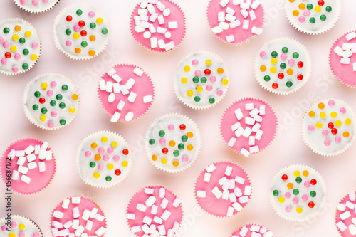 Colorful cupcakes on a white background.