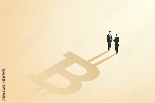Businessmen shaking hands agree bitcoin exchange.
