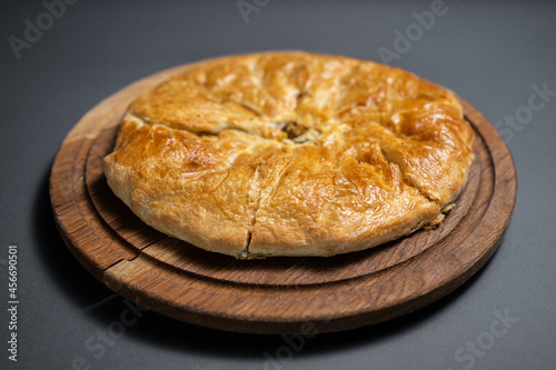 georgian khachapuri with mushrooms and potato or cheese pie on wooden board