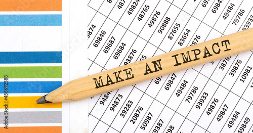 Business concept MAKE AN IMPACT text on the pencil on chart background photo