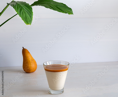 Low-calorie dessert of fermented baked milk or homemade kefir. Pannacotta with pear, convenient for weight loss.