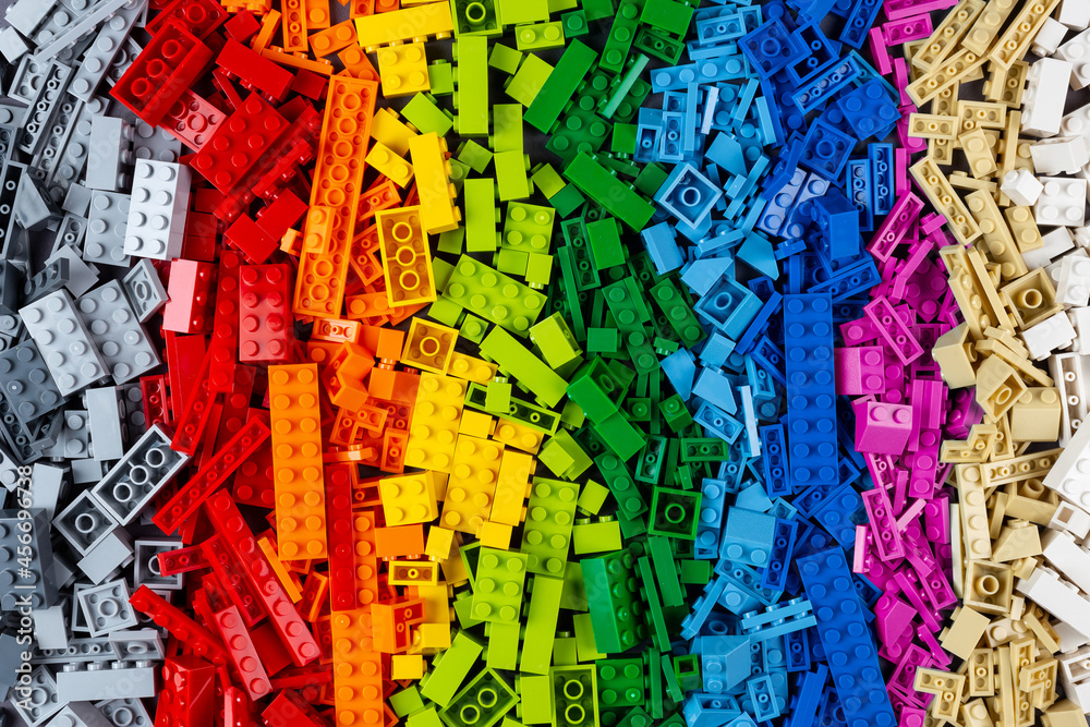 top view pile of many various colorful rainbow colored stackable plastic toy bricks. childhood education development concept