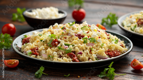 Couscous salad with sun dried tomatoes, cucumber, red onion and feta cheese. healthy food.