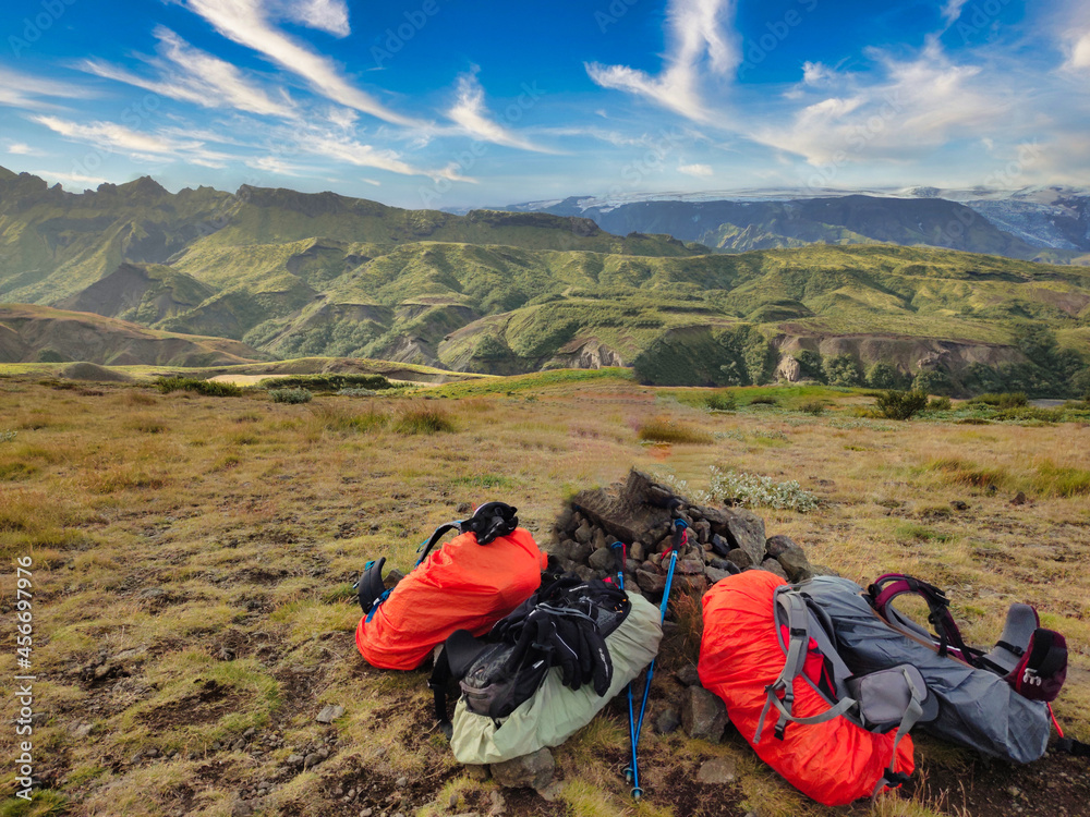 Fototapeta premium Backpacks placed on hill in mountains