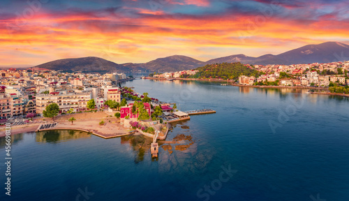 Colorful summer cityscape of Chalcis town. Dramatic sunrise on Aegean sea, North Euboean Gulf. Splendid morning scene of Euboea island, Greece, Europe. Traveling concept background.
