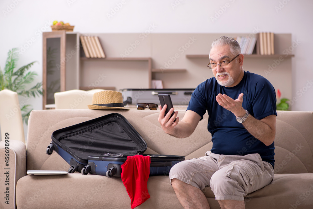 Old man preparing for trip at home Old man preparing for trip at home