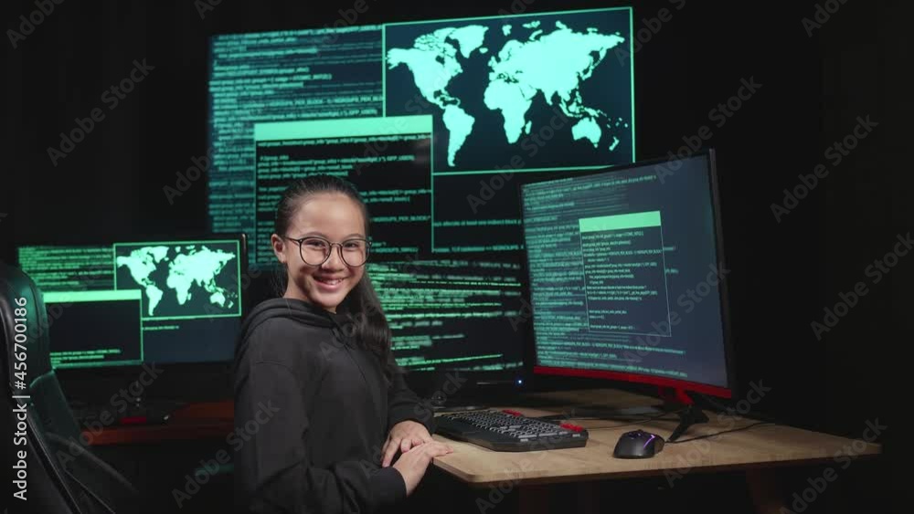 Asian Young Girl Hacker Hacking With Multiple Computer Screens And Smiling To Camera In Dark Room
Asian Young Girl Hacker Hacking With Multiple Computer Screens And Smiling To Camera In Dark Room