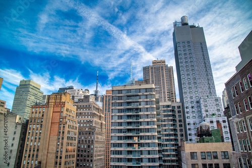 Modern and old buildings and skyscrapers of Midtown Manhattan under a blue sky, New York City - NY - USA. © jovannig
