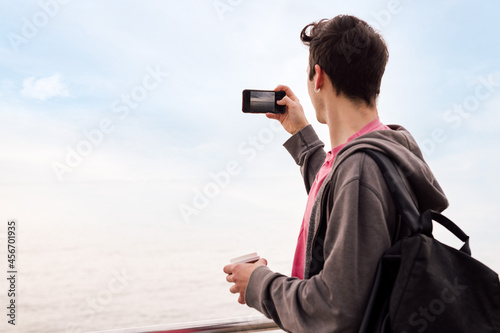 young man taking a photo with a mobile phone