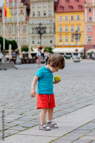 little toddler boy walking on the pavement in the old town © Masson