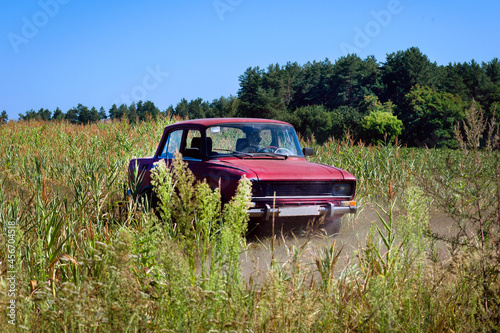 Old Soviet car drives off-road in a field