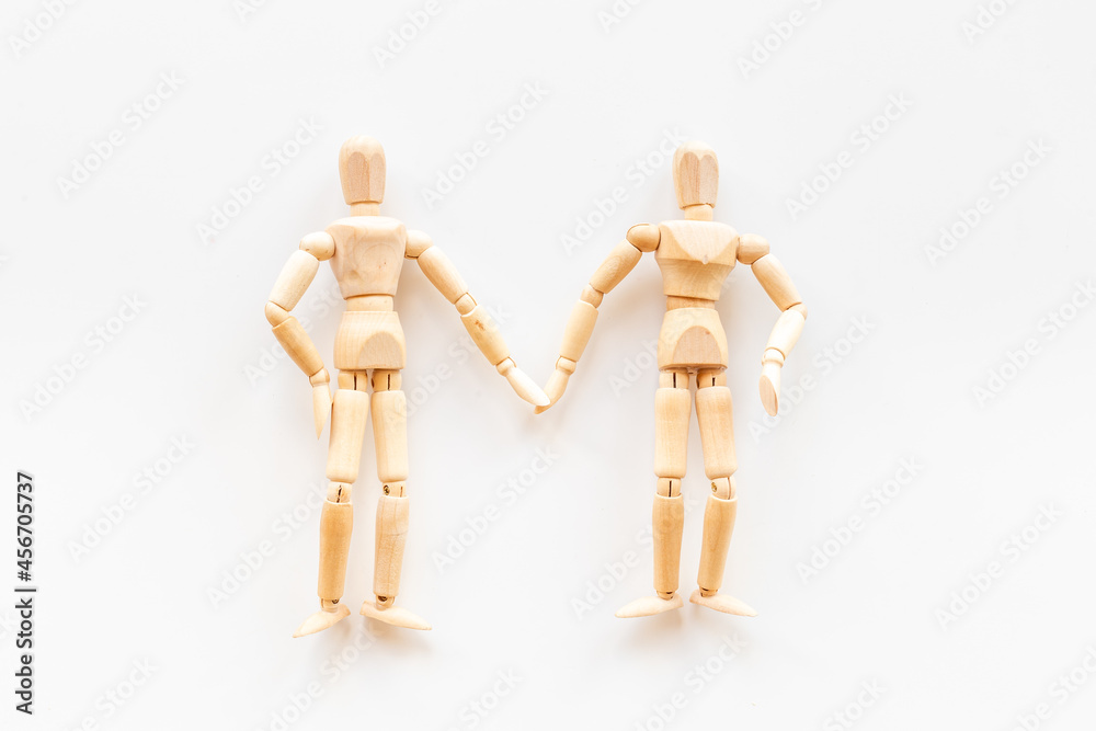 Two wooden figure connection - emotional communication concept Two wooden figure connection - emotional communication concept