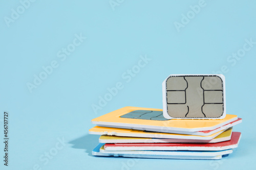 Naklejka Different SIM cards on light blue background. Space for text