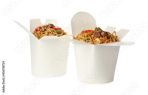 Boxes of wok noodles with vegetables and meat isolated on white